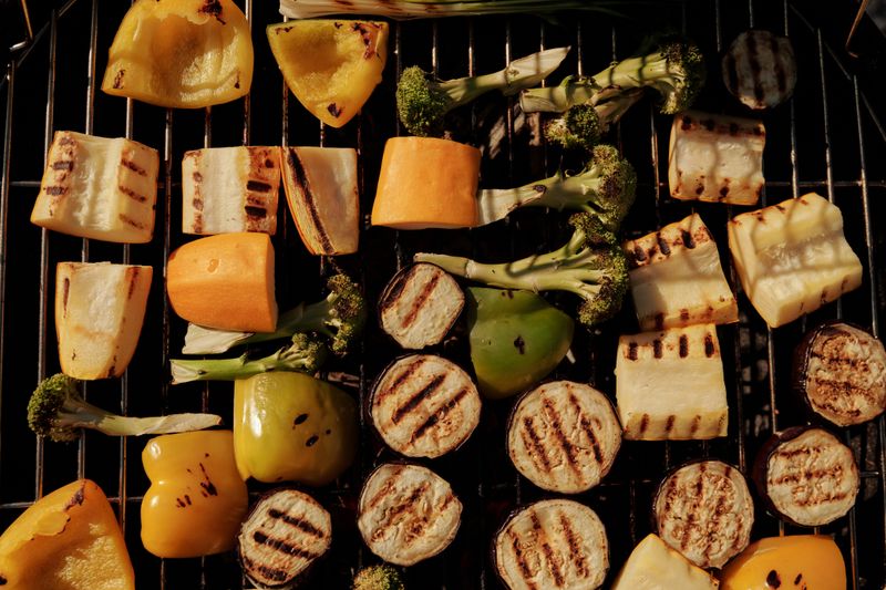 Assorted grilled vegetables including eggplant, peppers and broccoli on a barbecue grill